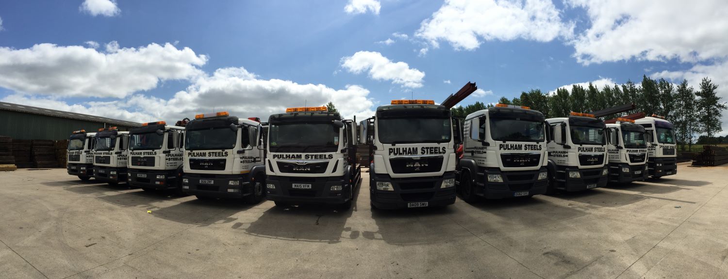 panoramic view of steel delivery trucks